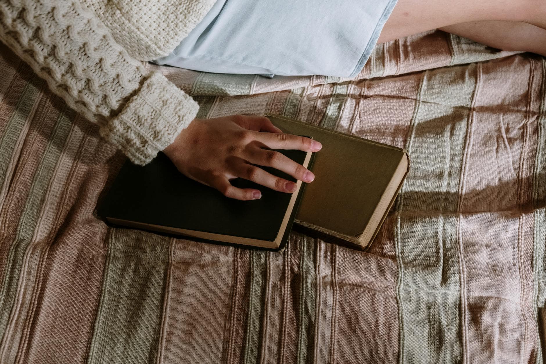 woman with notebooks on bed