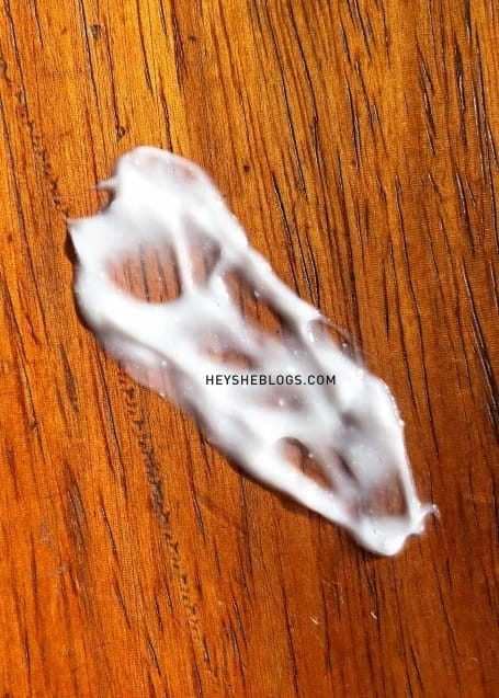 A close up photo showing the consistency and texture of the illiyoon ceramide ato concentrate cream. Also seen in the image are the ceramide capsules infused in it.