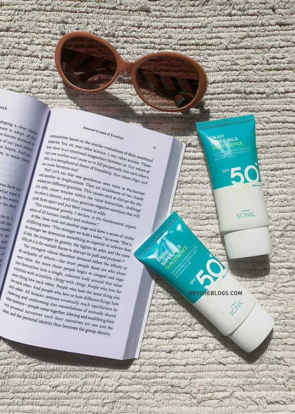 a tube of the scinic enjoy super mild sun essence sunscreen